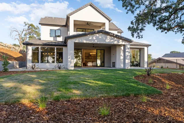 a dining room with furniture a chandelier and wooden floor