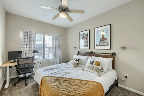 a bedroom with a large bed and a window