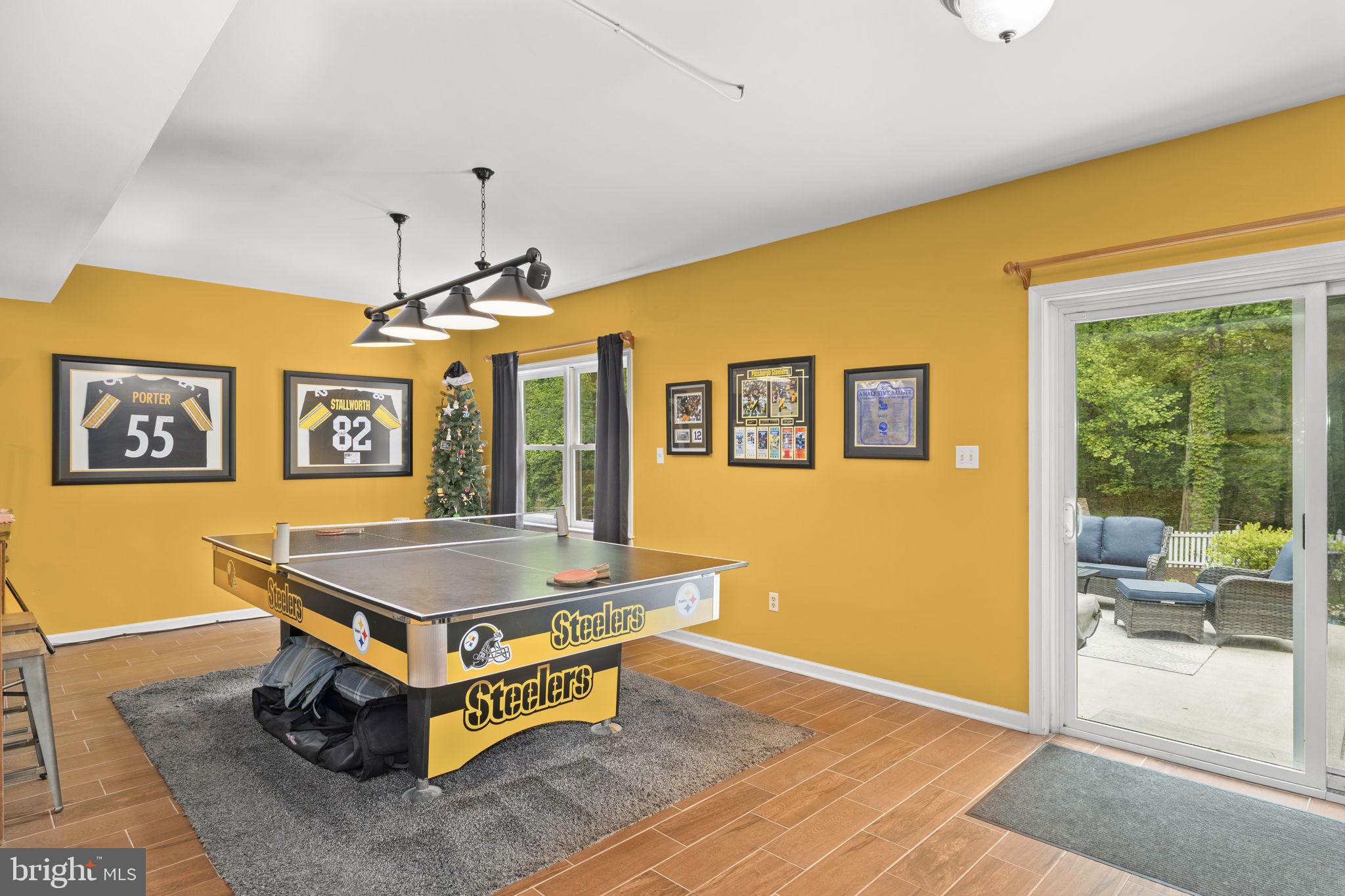 100 Boscobel Road Fredericksburg, VA 22405 - Photo 52 of 67 a living room with a table tennis table and paintings on the wall