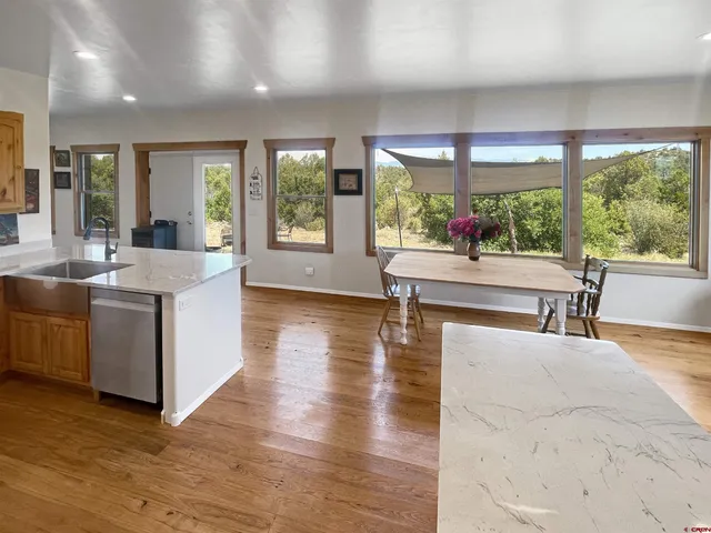 a living room with furniture and large windows