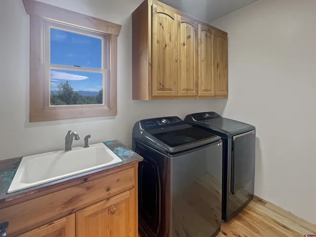 a utility room with a sink and a washer dryer