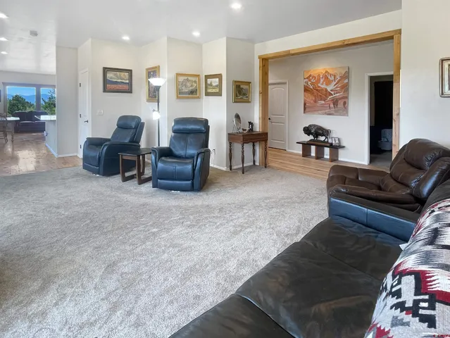 a living room with furniture and kitchen view