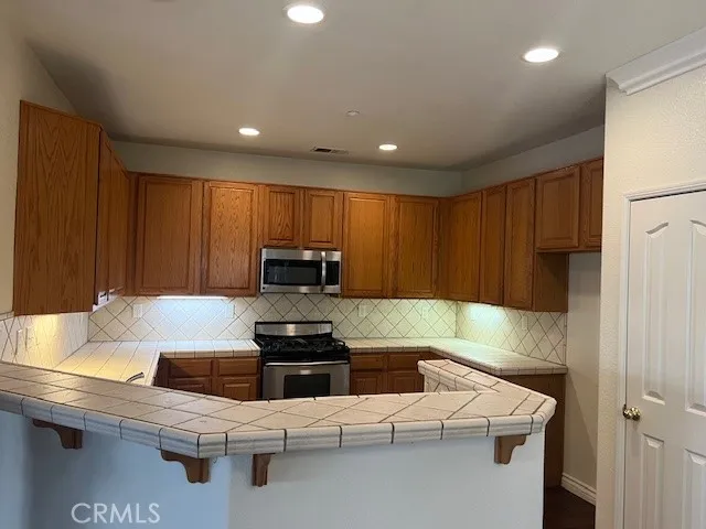 a kitchen with cabinets appliances and a counter top space