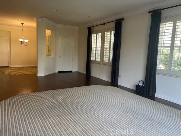 a view of an empty room with glass door and a window