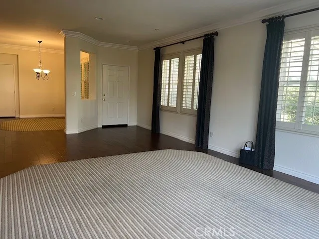 a view of an empty room with glass door and a window