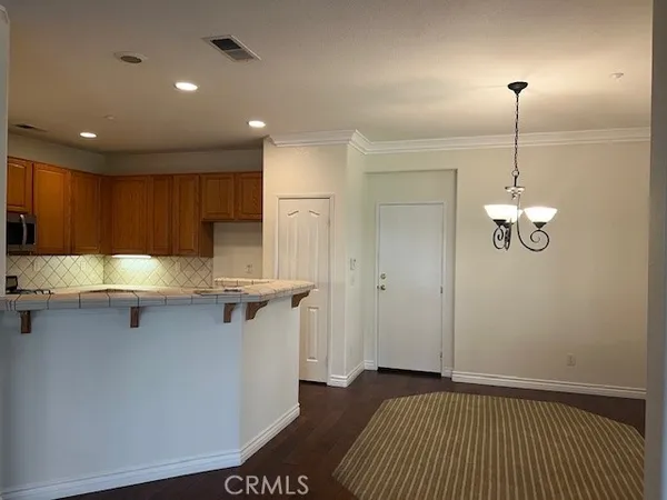 a kitchen with kitchen island a counter top space appliances and cabinets