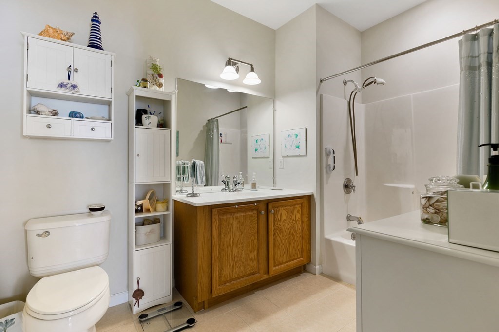 107 Clocktower Drive, Unit 107 Waltham, MA 02452 - Photo 6 of 13 a bathroom with a granite countertop sink toilet and shower