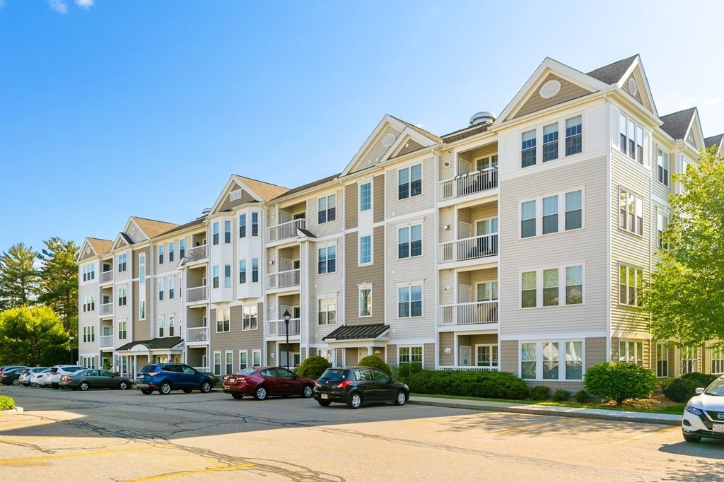 107 Clocktower Drive, Unit 107 Waltham, MA 02452 - Photo 9 of 13 a front view of a building with street view
