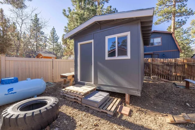 a backyard of a house with outdoor seating