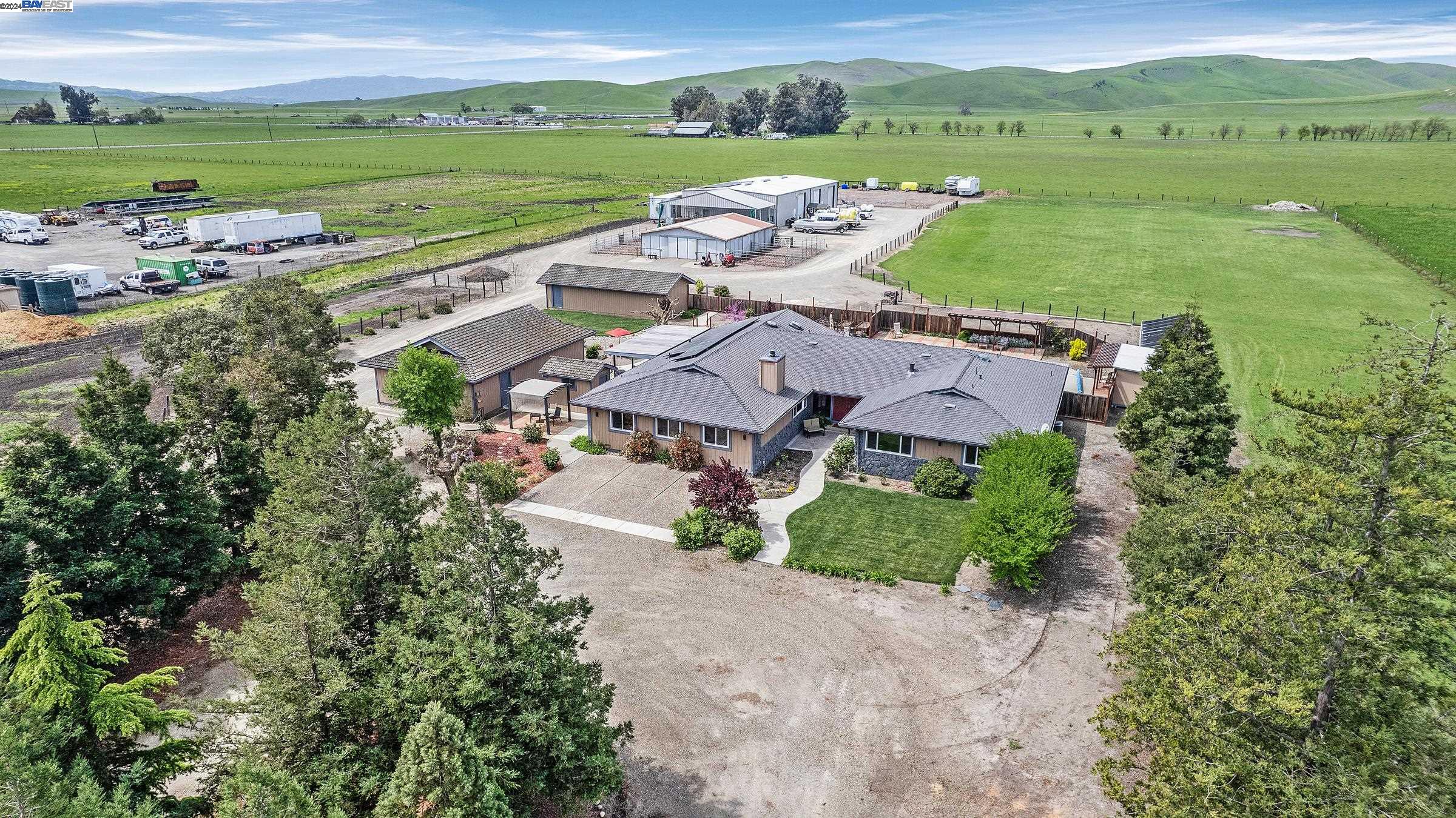an aerial view of a city with lots of residential buildings and mountain view in back
