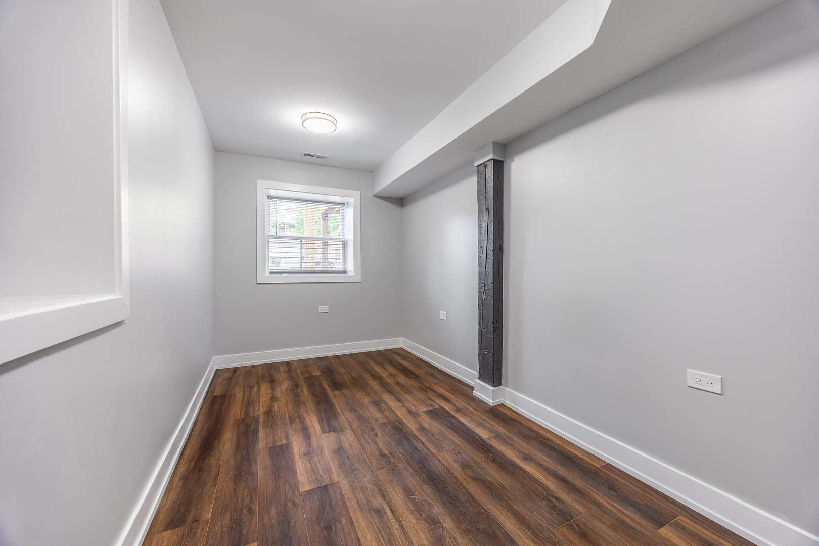 3328 West Congress Parkway, Unit G Chicago, IL 60624 - Photo 11 of 12 an empty room with wooden floor and windows