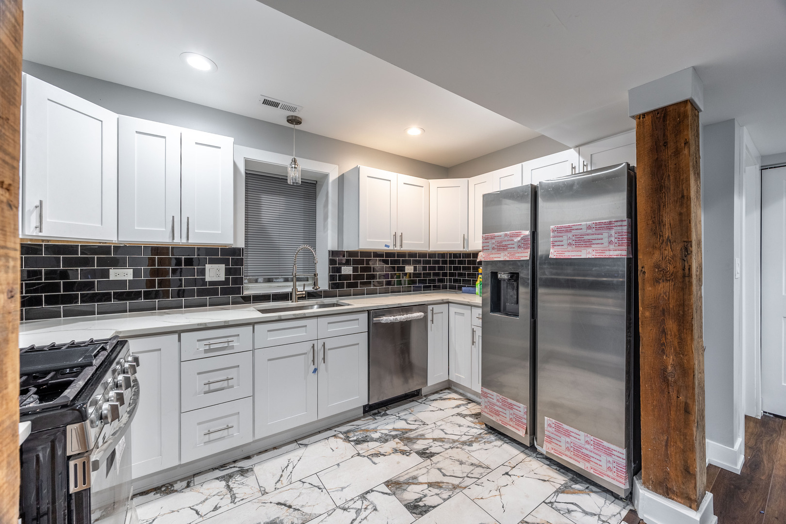 3328 West Congress Parkway, Unit G Chicago, IL 60624 - Photo 3 of 12 a kitchen with stainless steel appliances granite countertop a refrigerator a sink and white cabinets