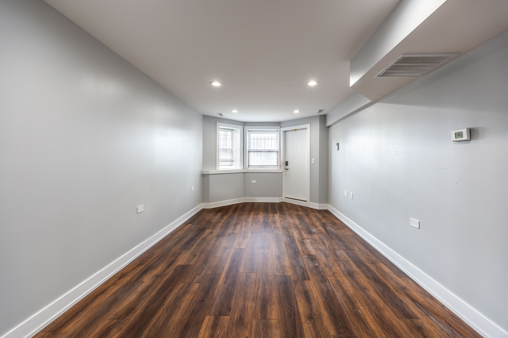 3328 West Congress Parkway, Unit G Chicago, IL 60624 - Photo 4 of 12 wooden floor in an empty room with a window