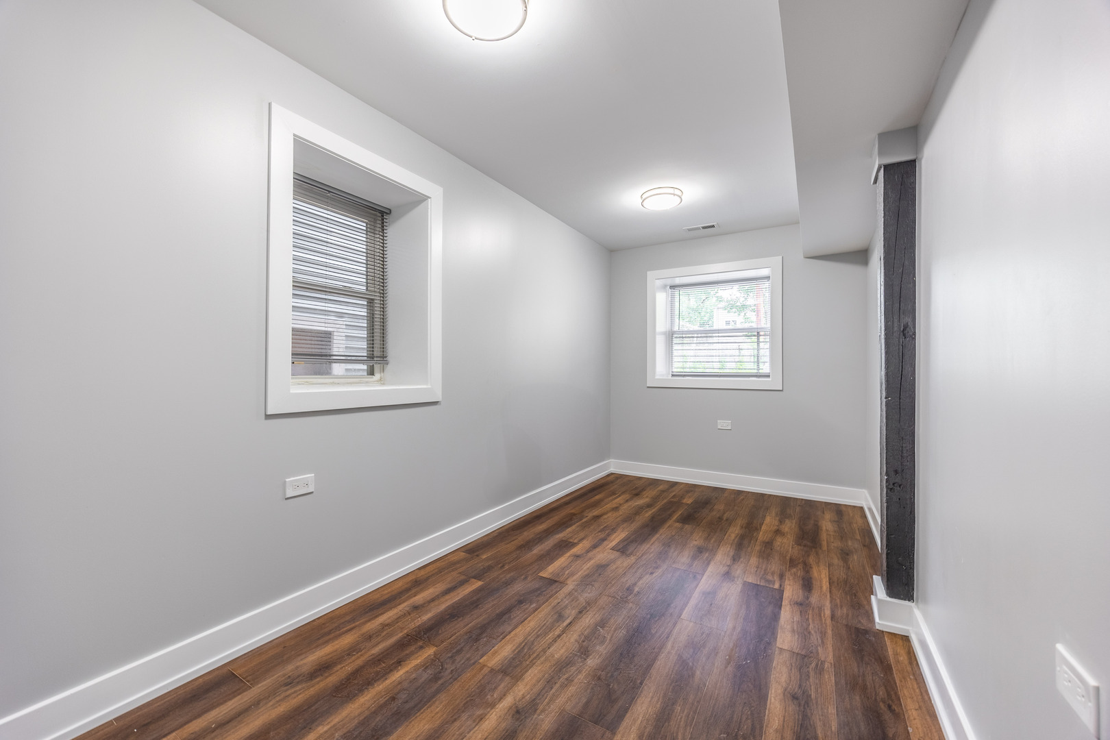 3328 West Congress Parkway, Unit G Chicago, IL 60624 - Photo 8 of 12 an empty room with wooden floor and windows