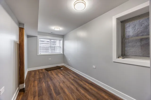 a view of a room with wooden floor and fan