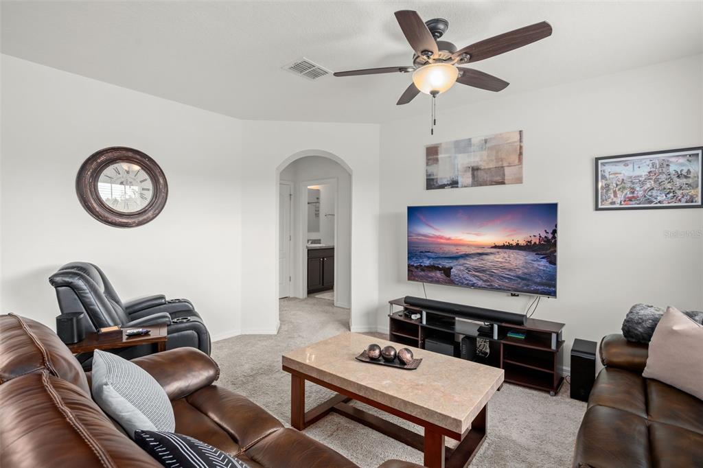 3449 Seneca Club Loop, Unit 24101 Orlando, FL 32808 - Photo 13 of 29 a living room with furniture and a flat screen tv