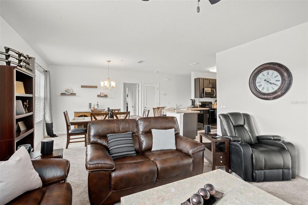 3449 Seneca Club Loop, Unit 24101 Orlando, FL 32808 - Photo 15 of 29 a living room with furniture and a view of kitchen