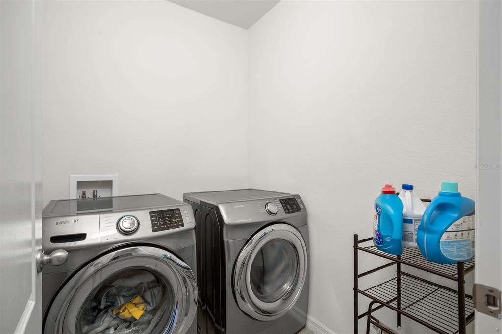 3449 Seneca Club Loop, Unit 24101 Orlando, FL 32808 - Photo 19 of 29 a utility room with dryer and washer