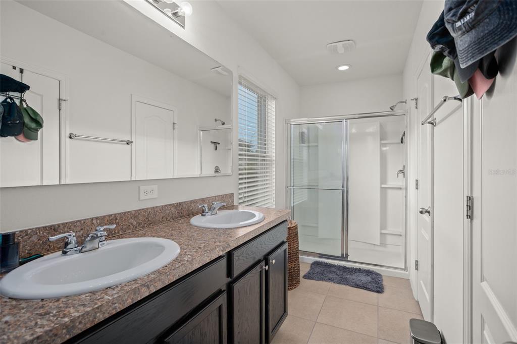 3449 Seneca Club Loop, Unit 24101 Orlando, FL 32808 - Photo 10 of 29 a bathroom with a sink double vanity and shower