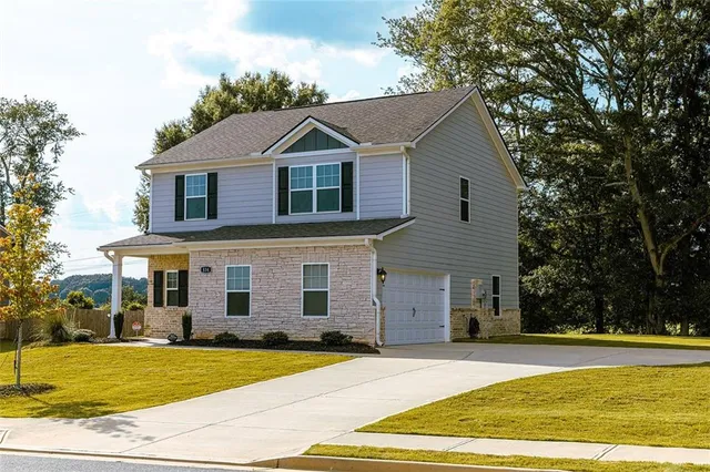 a front view of a house with a yard and garage