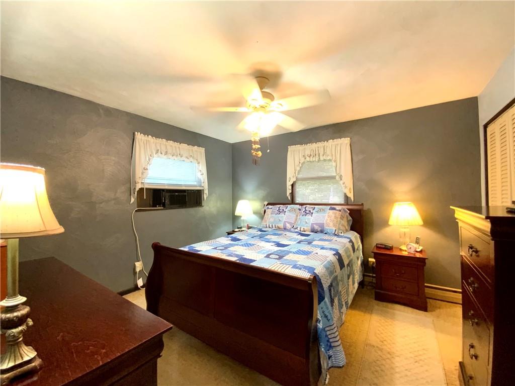 245 Murdocksville Road Clinton, PA 15026 - Photo 11 of 28 a bedroom with a bed and a lamp on dresser