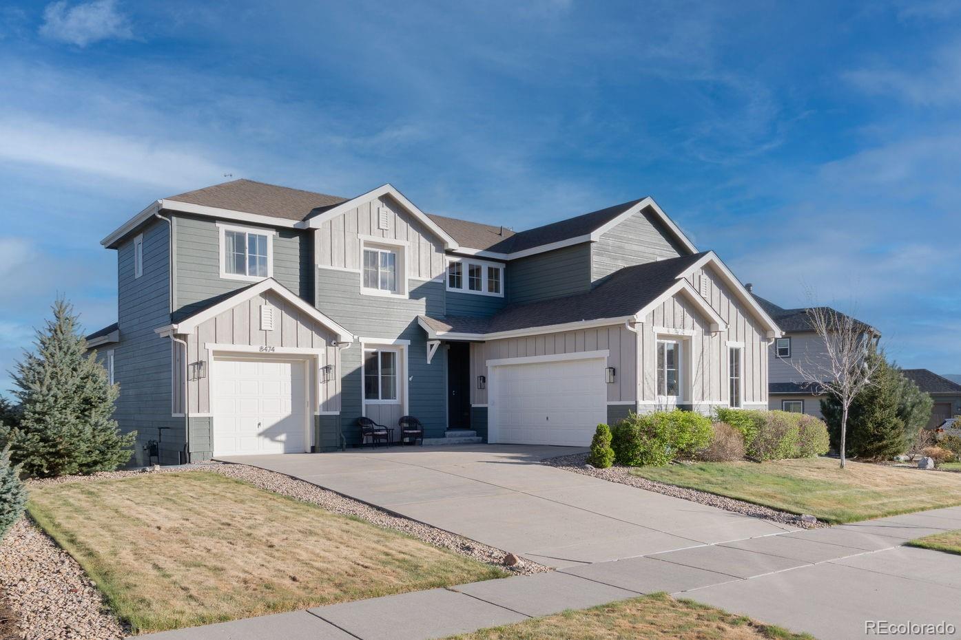 8474 Poppy Street Arvada, CO 80007 - Photo 1 of 40 a front view of a house with a yard