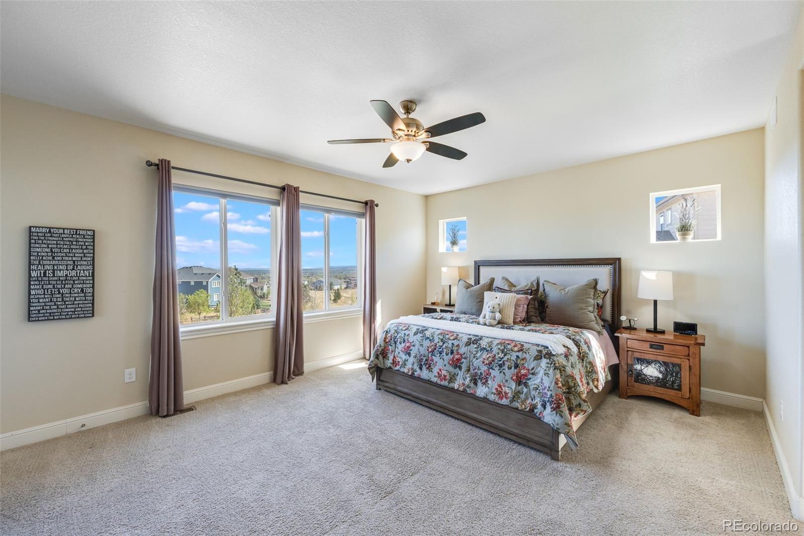 8474 Poppy Street Arvada, CO 80007 - Photo 11 of 40 a spacious bedroom with a bed and a large window