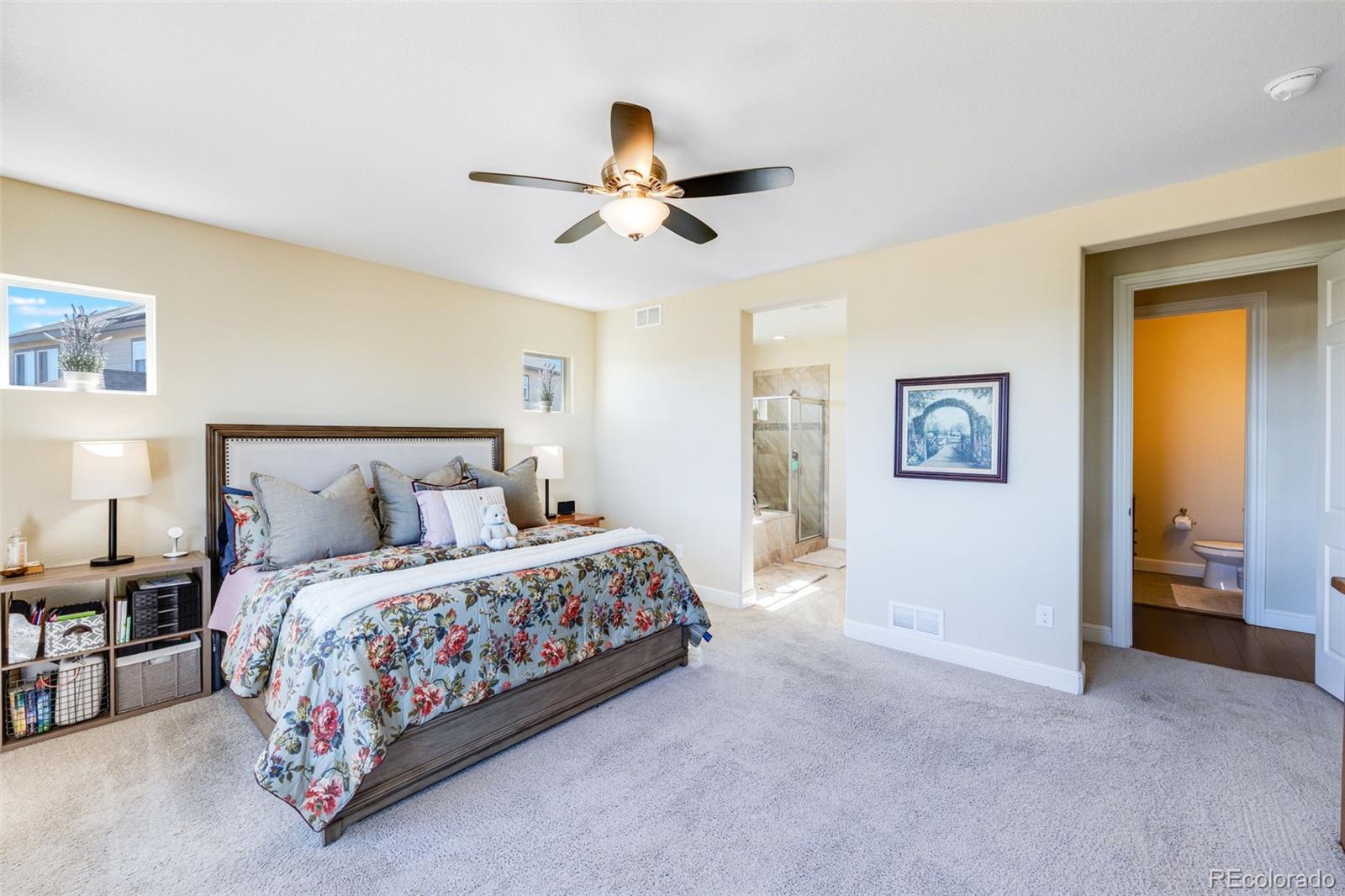 8474 Poppy Street Arvada, CO 80007 - Photo 12 of 40 a bedroom with a bed and a ceiling fan