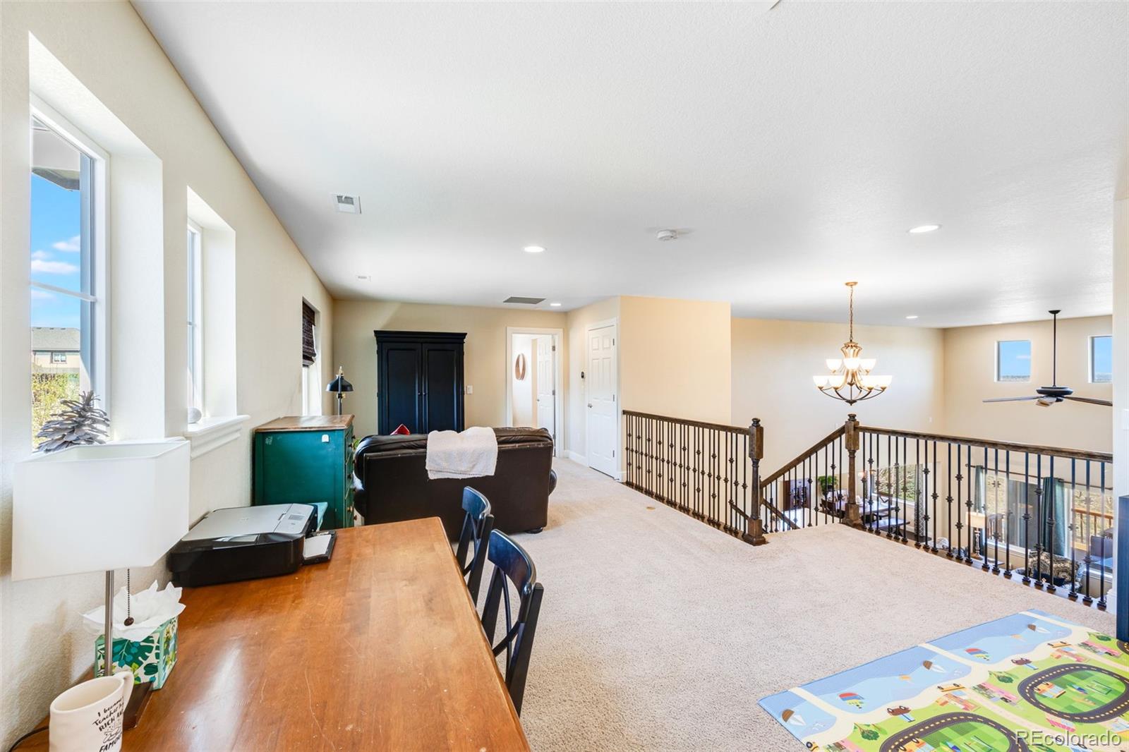8474 Poppy Street Arvada, CO 80007 - Photo 19 of 40 a bedroom with furniture and a wooden floor