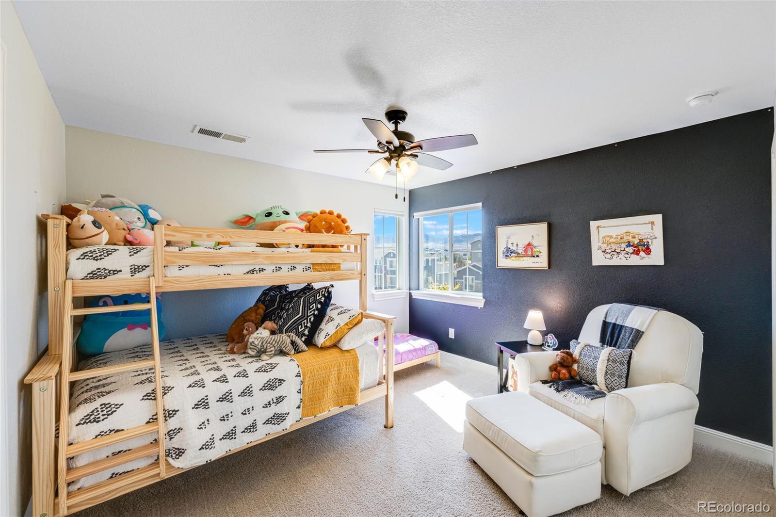 8474 Poppy Street Arvada, CO 80007 - Photo 20 of 40 a bed room with a bed and a chandelier