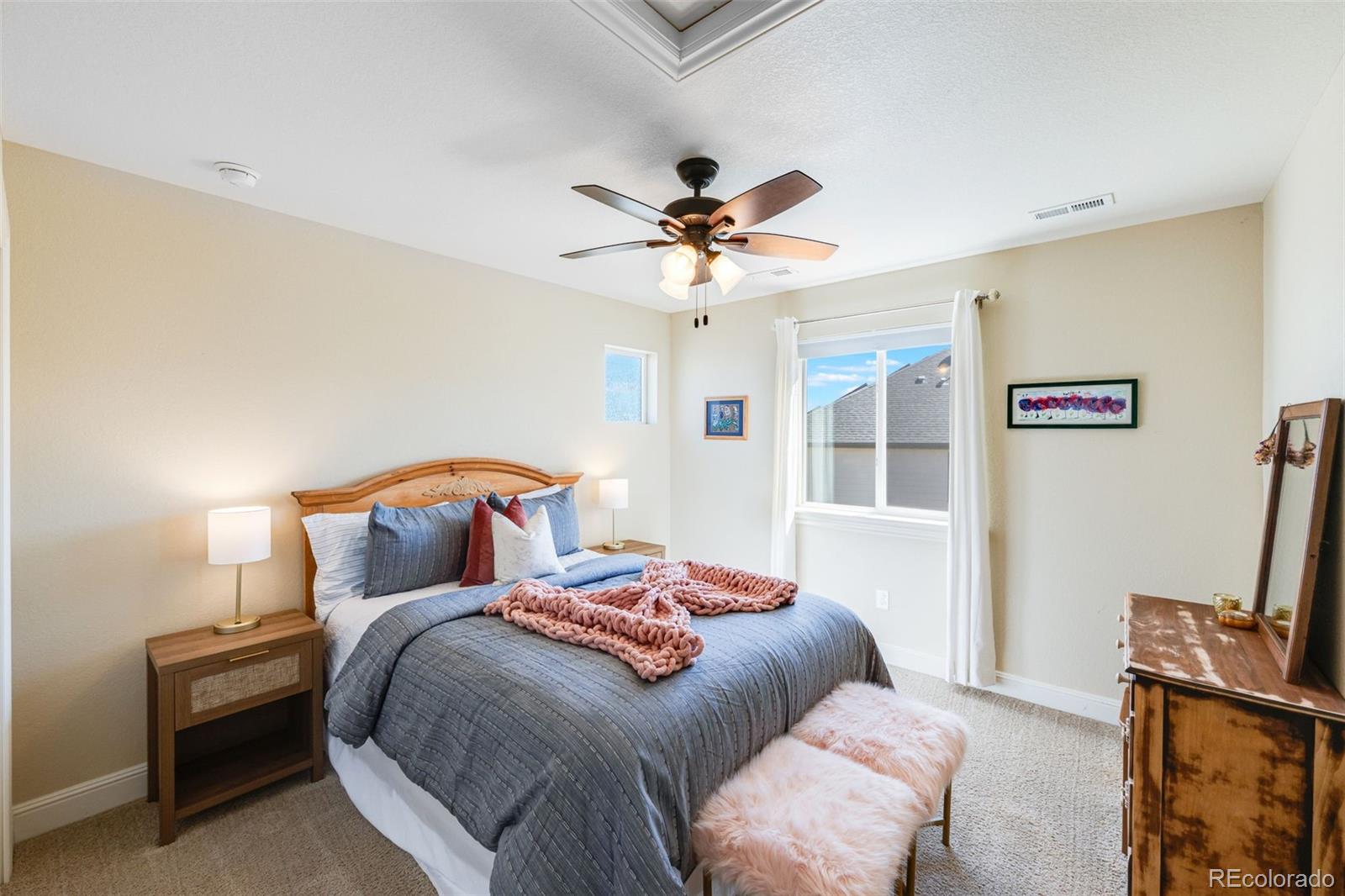 8474 Poppy Street Arvada, CO 80007 - Photo 21 of 40 a bedroom with a bed furniture and a flat screen tv