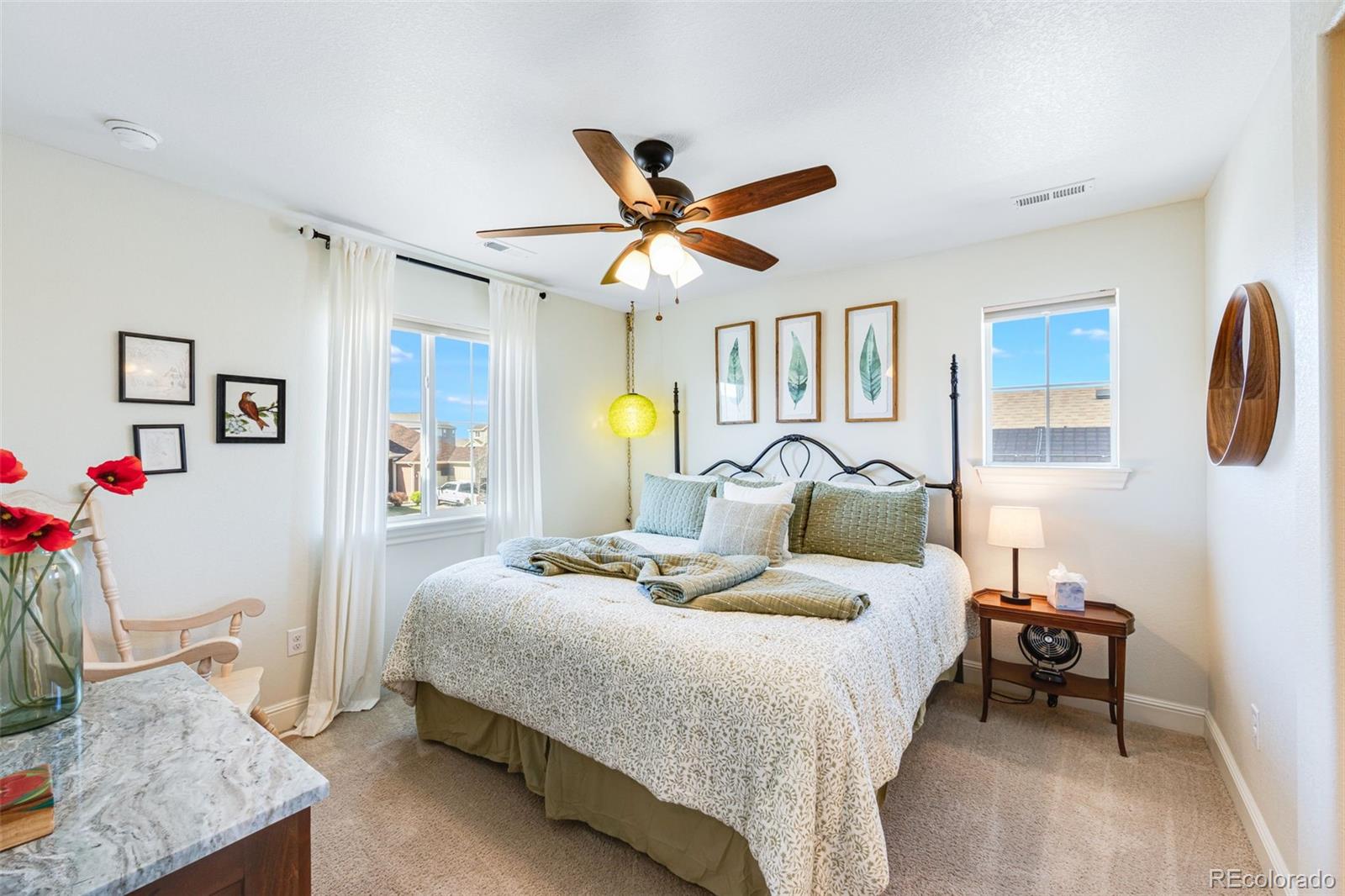8474 Poppy Street Arvada, CO 80007 - Photo 23 of 40 a bedroom with a bed and a chandelier