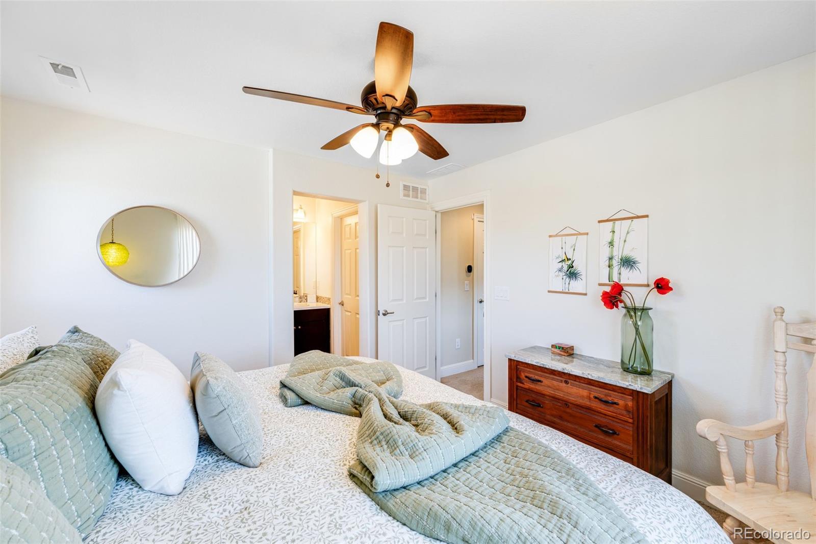 8474 Poppy Street Arvada, CO 80007 - Photo 25 of 40 a bedroom with a bed and wooden floor