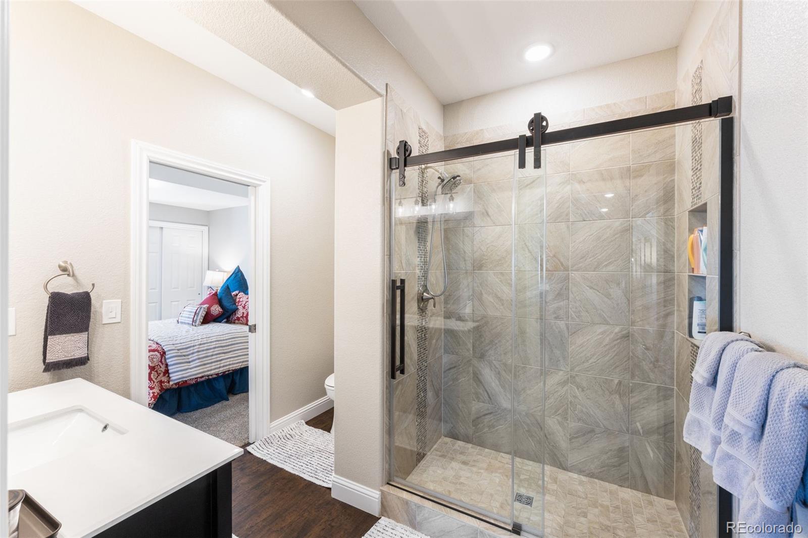 8474 Poppy Street Arvada, CO 80007 - Photo 28 of 40 a en suite bathroom with a shower