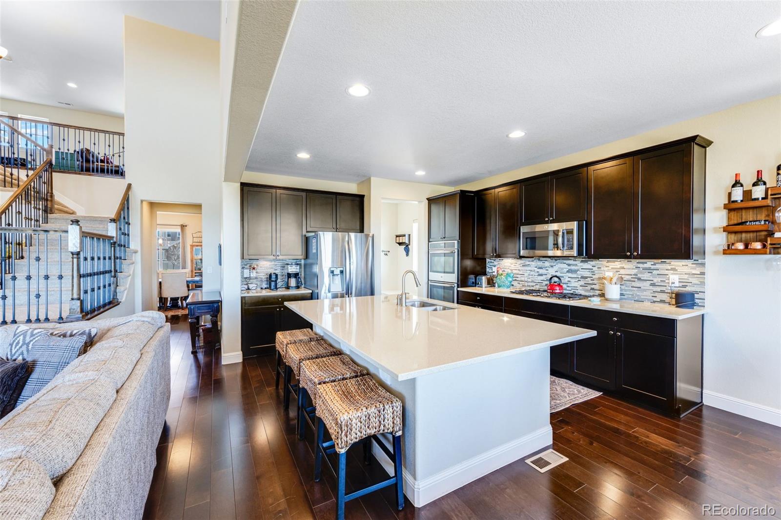 8474 Poppy Street Arvada, CO 80007 - Photo 3 of 40 a large kitchen with a table and chairs