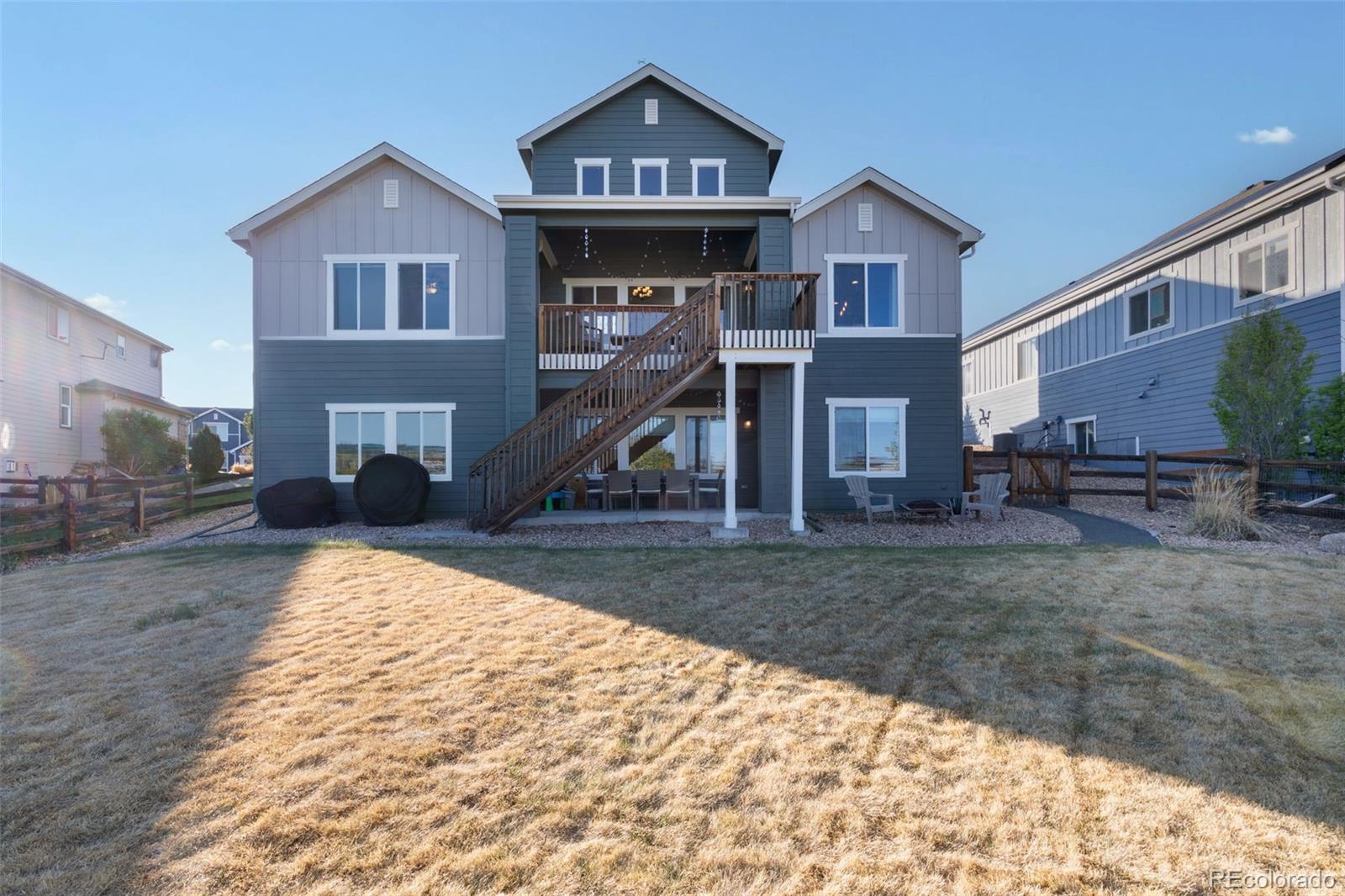 8474 Poppy Street Arvada, CO 80007 - Photo 36 of 40 a front view of a house with a yard