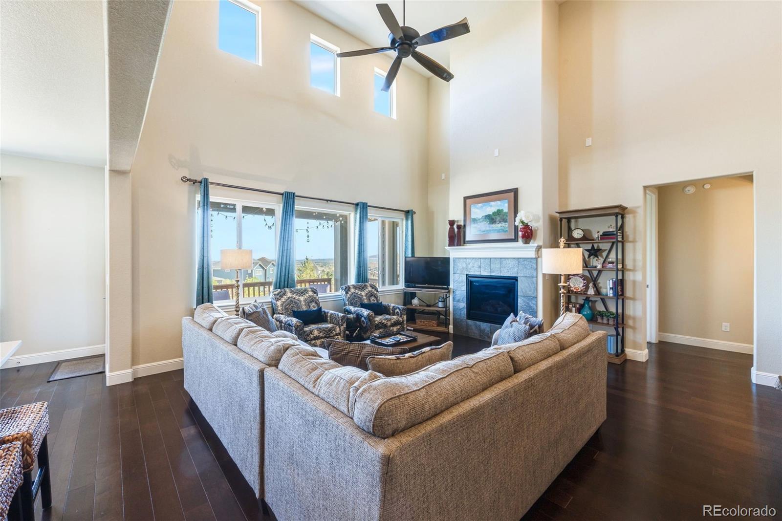 8474 Poppy Street Arvada, CO 80007 - Photo 6 of 40 a living room with furniture fireplace and a wooden floor