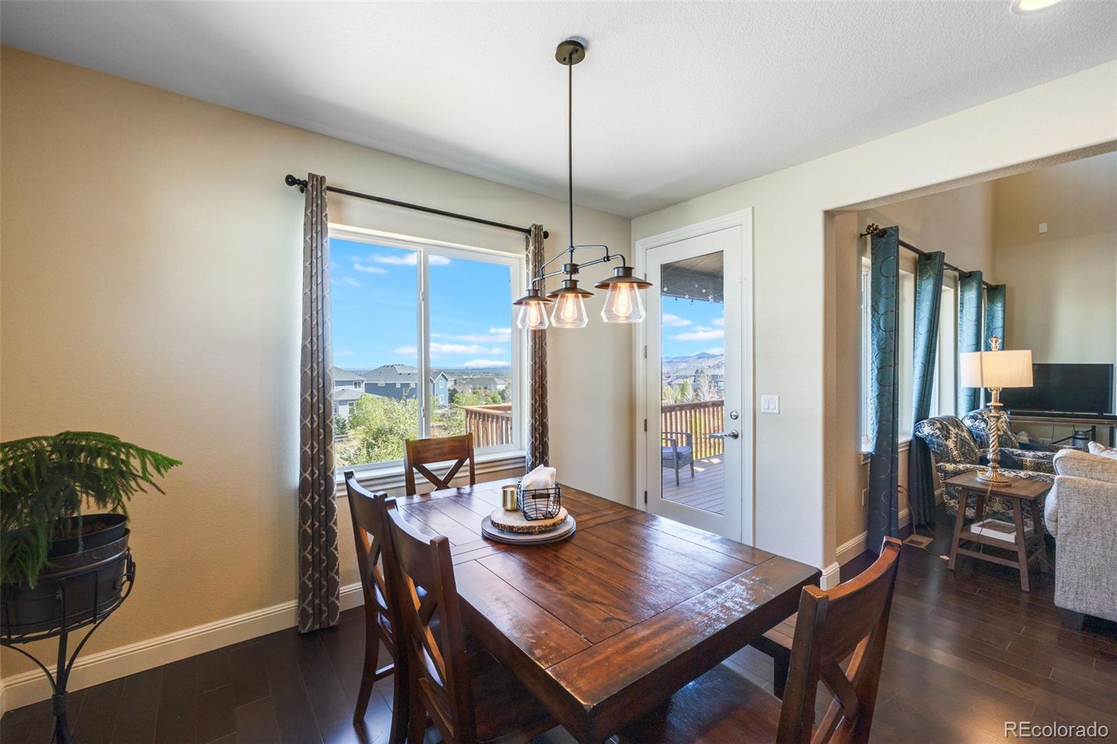 8474 Poppy Street Arvada, CO 80007 - Photo 7 of 40 a view of a dining room with furniture window and wooden floor