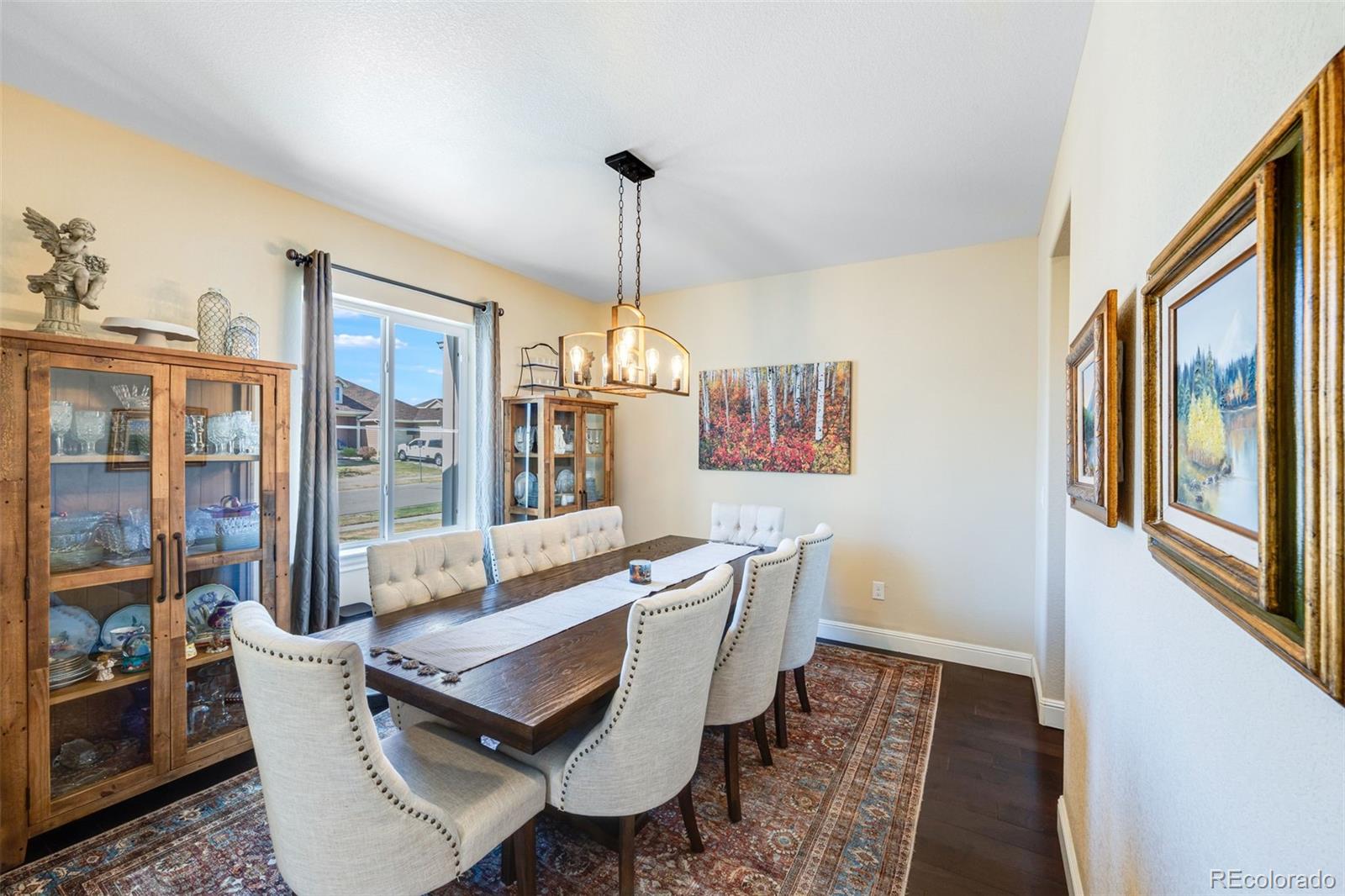 8474 Poppy Street Arvada, CO 80007 - Photo 8 of 40 a dining room with furniture a chandelier and window