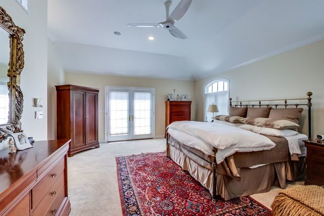 416 Wisner Street Park Ridge, IL 60068 - Photo 26 of 49 a spacious bedroom with a bed a dresser and windows