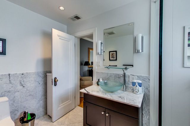 416 Wisner Street Park Ridge, IL 60068 - Photo 38 of 49 a bathroom with a granite countertop sink a mirror and shower