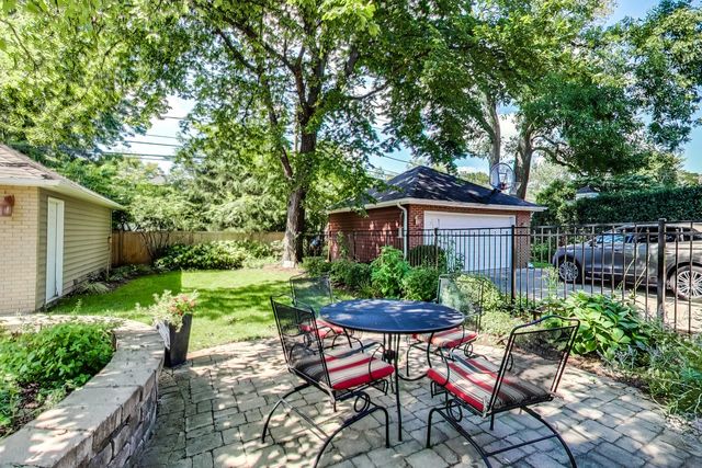 416 Wisner Street Park Ridge, IL 60068 - Photo 46 of 49 a view of a patio with table and chairs potted plants and large tree