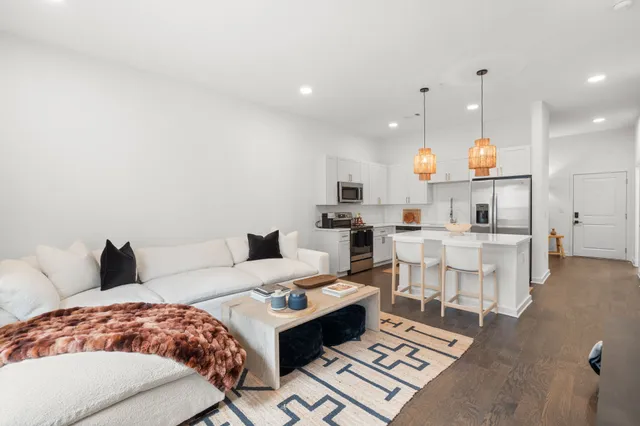 a living room with furniture and kitchen view