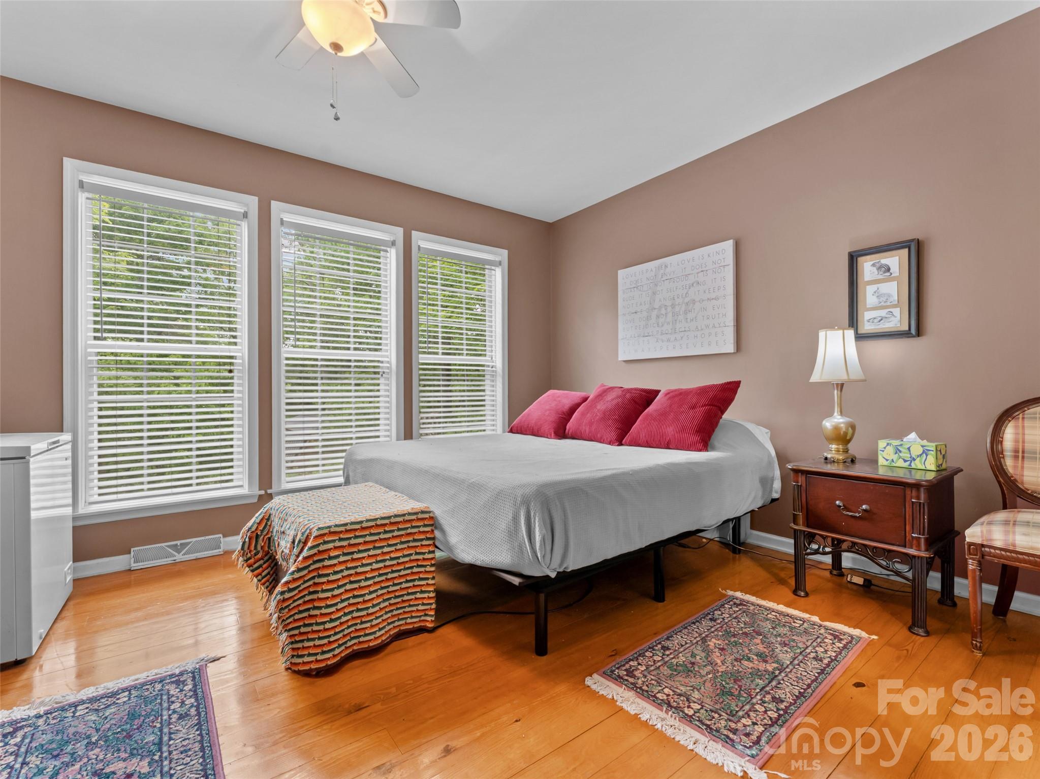 103 Old Southside Road Saluda, NC 28773 - Photo 24 of 48 a bedroom with a bed a chair and a chandelier