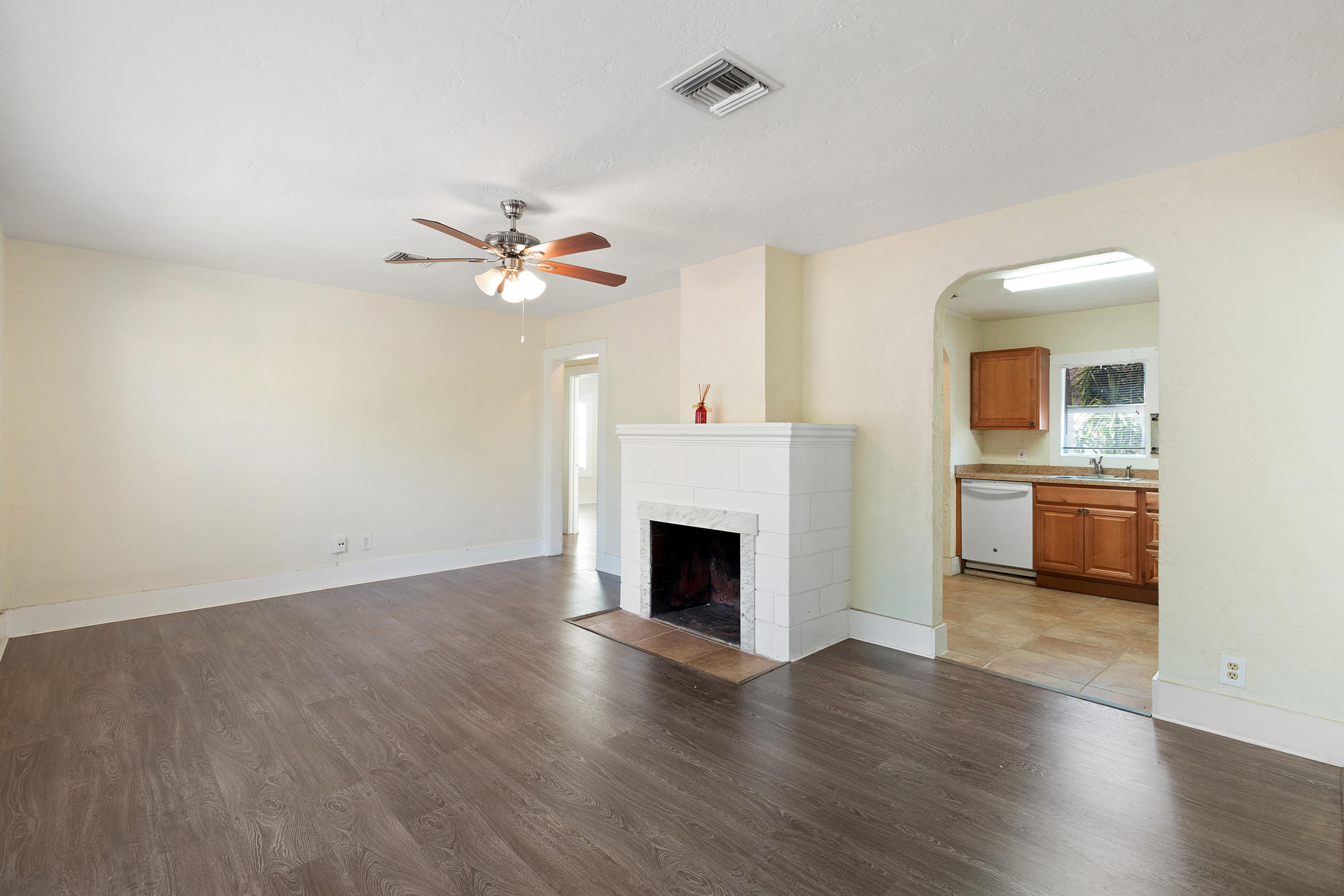 534 Hampton Road West Palm Beach, FL 33405 - Photo 9 of 29 an empty room with fireplace and wooden floor