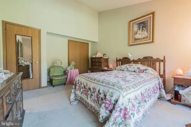 a bedroom with a bed and a mirror