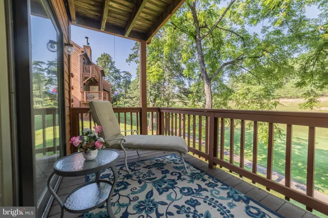 a view of balcony with furniture and garden
