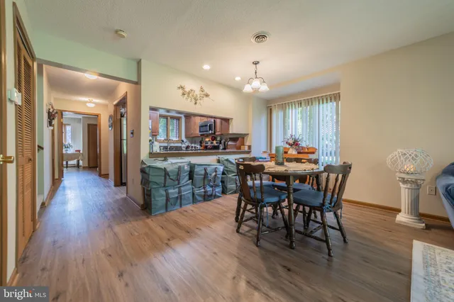 a view of a dining room with furniture and wooden floor
