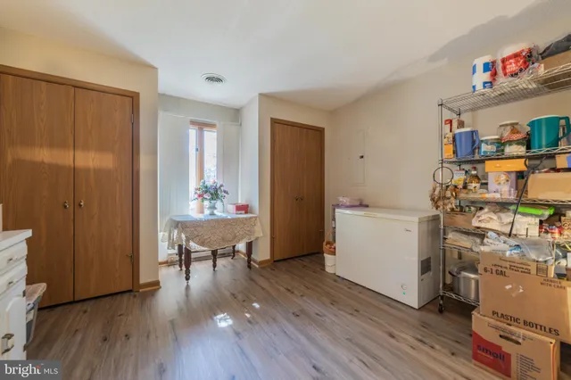 a view of a workspace with furniture and wooden floor