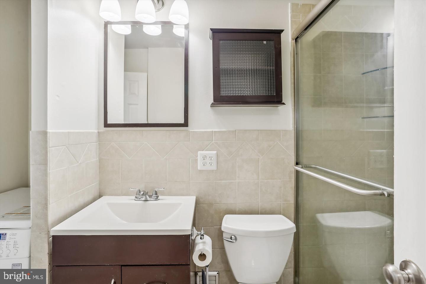 1900 Lyttonsville Road, Unit 602 Silver Spring, MD 20910 - Photo 17 of 43 a bathroom with a toilet sink and mirror